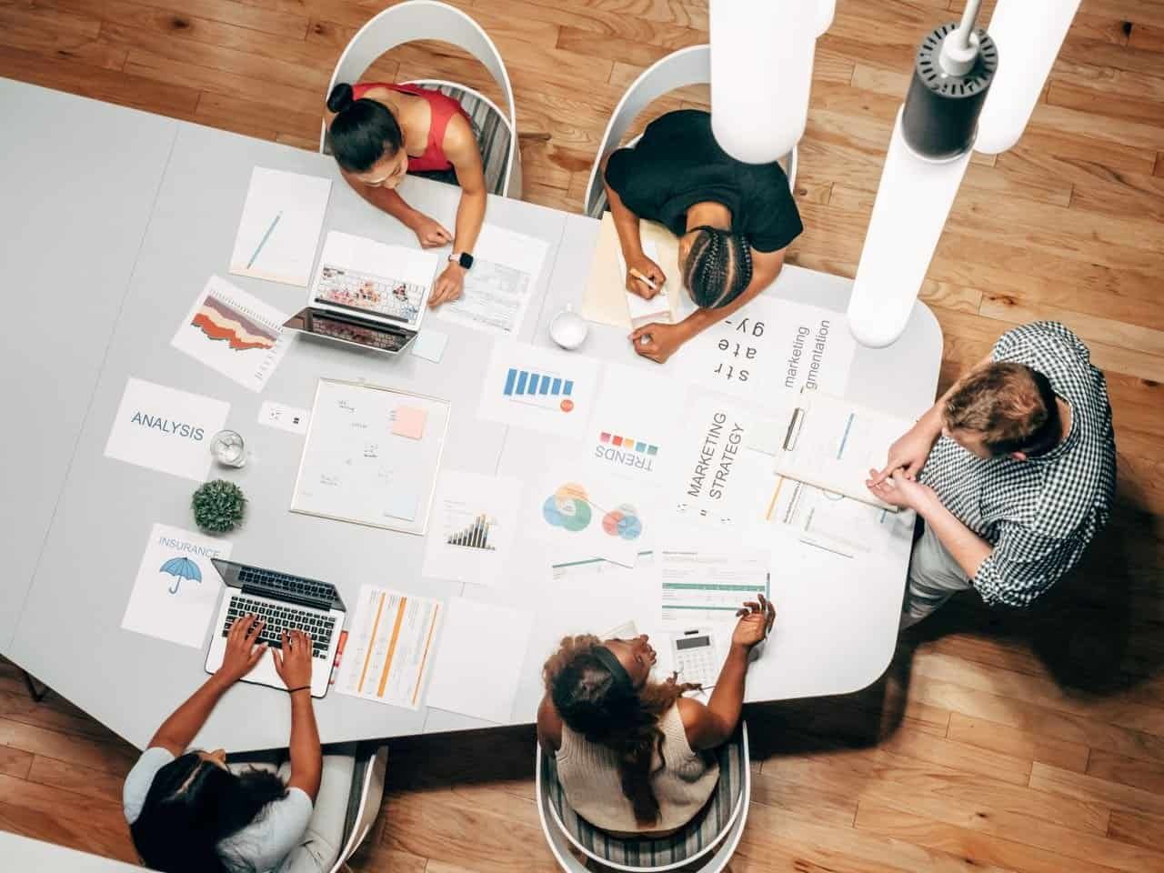 Home Diverse team collaborating on marketing strategy in a modern office setting.